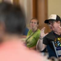 teacher answering a question at a professional learning, seated indoors